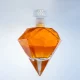 Diamond shaped glass bottle